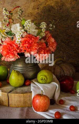 Still life with Fruits were placed together with a vase of flowers beautifully. Stock Photo