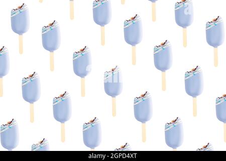Isolated bitten blue cookie ice creams on a stick on white background. Flat lay with ice cream. Icecream pattern. Stock Photo