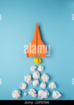 Launching paper rocket with jet stream of paper balls, creativity concept or new ideas metaphor, start up business , new year’s resolution Stock Photo