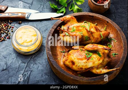 Roasted whole quail and spring vegetable salad.Meat food Stock Photo