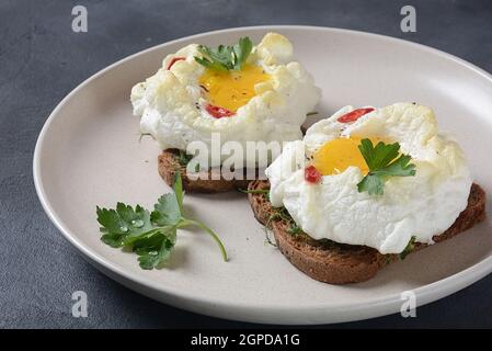 Delicate baked egg. Orsini eggs in the cloud. French breakfast.Cloud ...