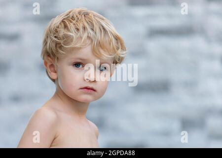 Funny child without t-shirt in the garden Stock Photo