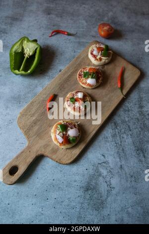 Popular Italian delicacy pizza. Ready to serve pizzas along with ingredients Stock Photo