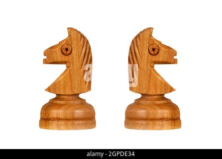 Brown and white knights back to back. Symmetrical pieces of chess Stock Photo