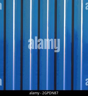 Diagonal pattern of metal profile. Fences from the galvanized iron painted by a polymeric covering. Stock Photo