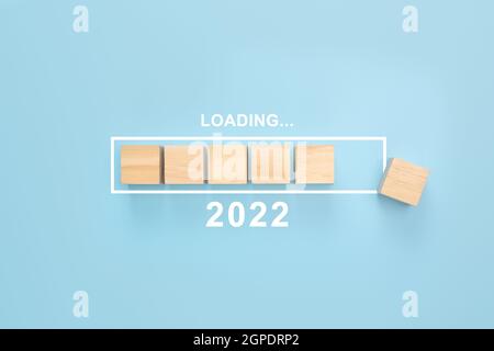 Business concept of planning 2022. Loading new year 2022 wood cube in progress bar. Loading year from 2021 to 2022. New year start concept Stock Photo