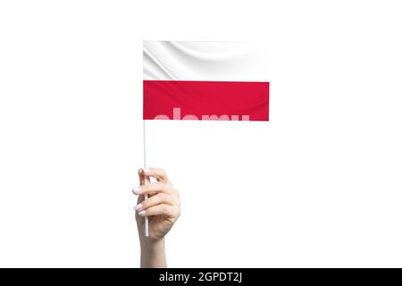 Beautiful female hand holding Poland flag, isolated on white background. Stock Photo