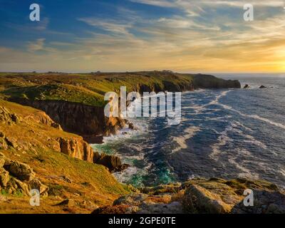 Evening golden hour looking from Mayon Cliff along the Cornish coastline towards Lands End. Near the cliff base is the wreck of the RMS Mülheim Stock Photo