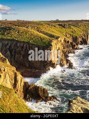 Evening golden hour looking from Mayon Cliff along the Cornish coastline towards Lands End. Near the cliff base is the wreck of the RMS Mülheim Stock Photo