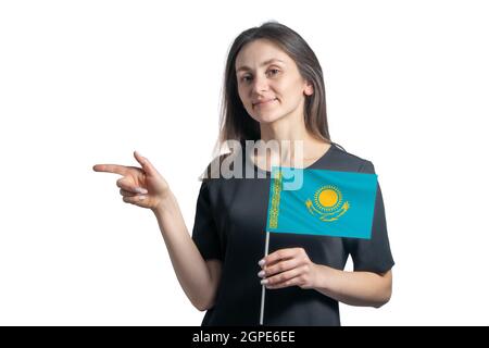 Happy young white woman holding flag Kazakhstan and points to the left isolated on a white background. Stock Photo