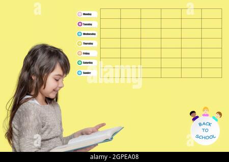 Cute tanned little girl is reading book: The  school weekly planner is on the yellow background. Monday starts week. Stock Photo