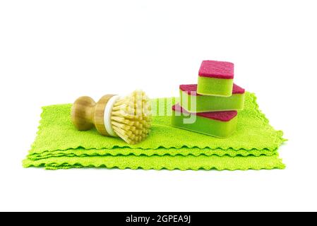 Multicolored cleaning sponges and dish brushes on microfiber cloth isolated on a white background. House cleaning supplies Stock Photo