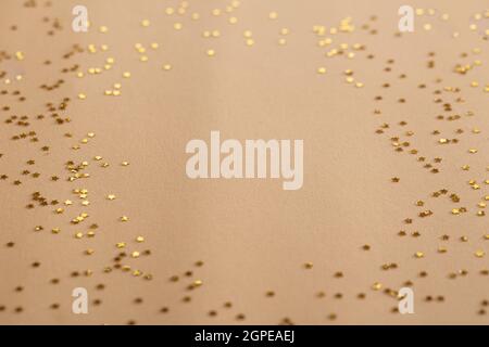 Golden sparkles stars on gold holiday background. Festive backdrop for your projects Stock Photo