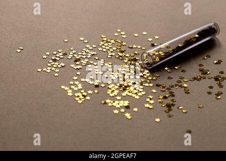 Golden sparkles stars on gold holiday background. Festive backdrop for your projects Stock Photo