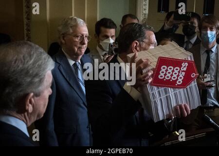 United States Senate Minority Leader Mitch McConnell (Republican of Kentucky), left, listens as United States Senator John Barrasso (Republican of Wyoming) holds up a copy of the $3.5 trillion infrastructure bill as he offers remarks at a press conference following the Senate Republican's policy luncheon at the US Capitol in Washington, DC, Tuesday, September 28, 2021. Photo by Rod Lamkey/CNP/ABACAPRESS.COM Stock Photo