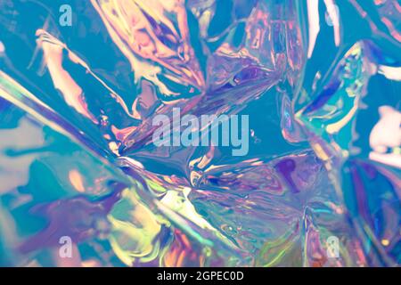 Blue defocused holographic backdrop. Wrinkled foil material. Fluid futuristic texture. Stock Photo