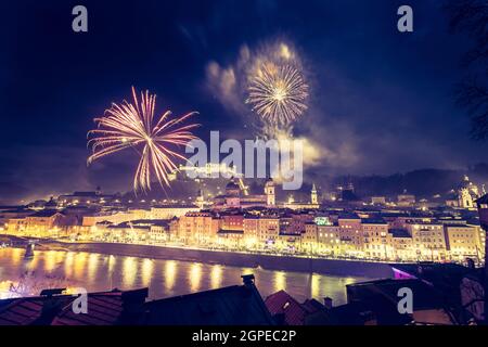 Colorful firework in the night: Old city of Salzburg and Festung Hohensalzburg at New Year’s Eve. Magic Stock Photo