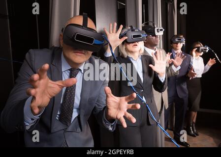 Excited man in virtual reality room Stock Photo