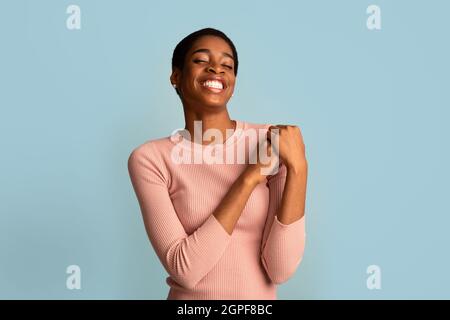 Great Mood. Happy Delighted Young African American Woman Standing Over Blue Background Stock Photo