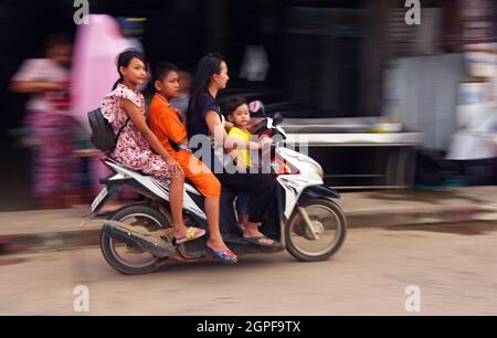 THAILAND, PHUKET, FOUR PEOPLE ON THE SAME MOTOR BIKE IN THE OLD TOWN Stock Photo