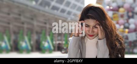 Lay off. Sacked. Fired business woman sitting on stairs of office building outside. Depressed young business woman unemployment due to coronavirus cri Stock Photo