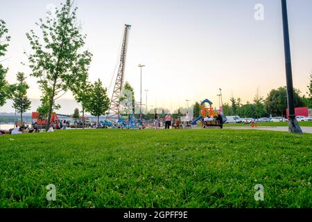 Beyoglu, Istanbul, Turkey - 06.27.2021: playground and slides for children in Haskoy public park and Turkish people in their leisure time in summer wi Stock Photo