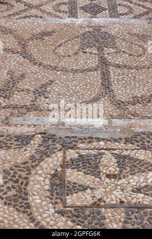 Decorated pebble stone street. Textured pavement sidewalk. Vertical Stock Photo