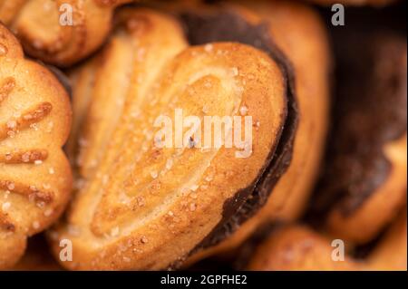 Curly cookies covered with chocolate icing, background image, close-up, selective focus Stock Photo