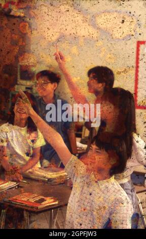 Austin Texas USA, September, 1991: Eager Vietnamese-American students raise their hands in junior high English as a Second Language class.  ©Bob Daemmrich Stock Photo