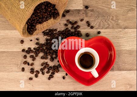 composition of coffee with grains and cups on wooden surface Stock Photo