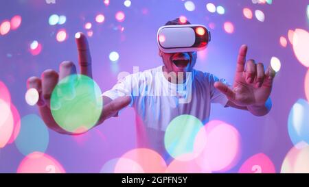 Excited black guy in virtual reality glasses, double exposure collage Stock Photo
