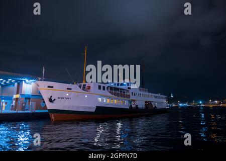 Beyoglu, Istanbul, Turkey - 07.07.2021: Istanbul passenger ship parked in Karakoy pier at night time and wait for people before moving for transportat Stock Photo