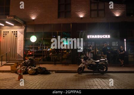 Beyoglu, Istanbul, Turkey - 07.07.2021: personnel of Starbucks at Karakoy region closing the coffee shop at night and going home for restaurant famous Stock Photo