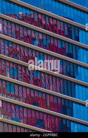 Red building reflections on an office building, close-up. Stock Photo