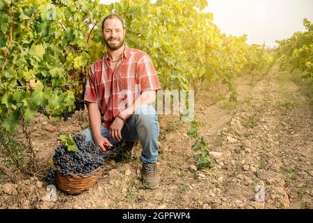 young farmer in the vineyard smiling happy Stock Photo