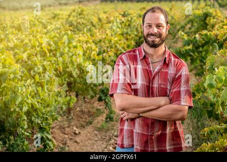 young self-confident farmer in the vineyard Stock Photo
