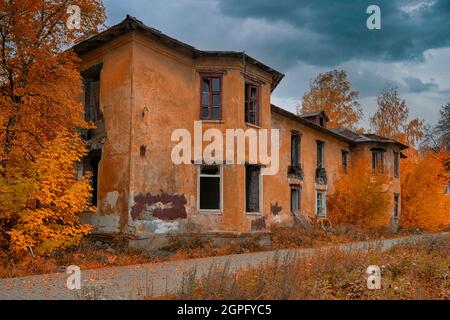 The ruins of a destroyed building in the city. Old abandoned collapsing building. Landscape with the ruins of the old buildings. Stock Photo