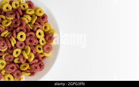bowl of whole whole grain cereal rings isolated on white background, healthy breakfast concept, plate of delicious rings with empty space for text Stock Photo
