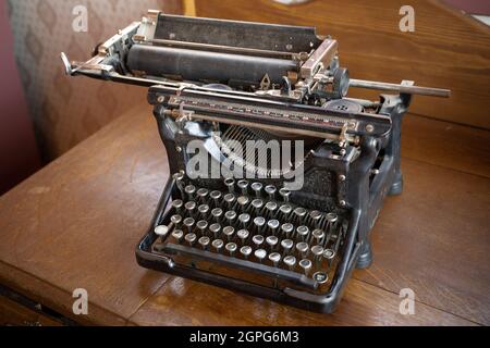 Vintage old antique black typewriter on a desk Stock Photo