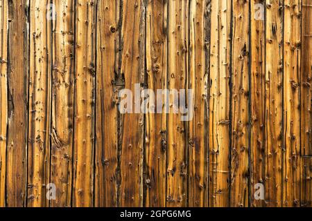 Old weathered vertical barn wood siding background Stock Photo