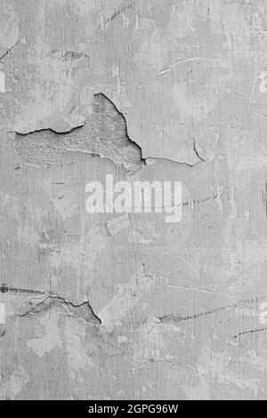 texture of a house wall with peeling gray paint and Stock Photo