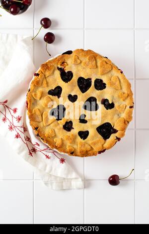 Homemade open cherry pie with lattice on a gray concrete background. Selective focus. Top view Stock Photo