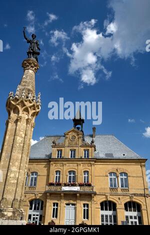 France, Doubs, Le Russey, square, city hall dated 19th century, fountain, column with statue of missionary Dominique Parrenin Stock Photo