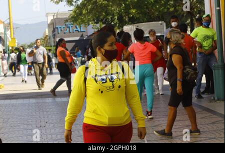 Valencia, Carabobo, Venezuela. 29th Sep, 2021. September 29, 2021. Venezuela will carry out a new economic reconversion, removing six zeros from the currency as of October 1, 2021. A womn walks for the comercial zone, in the Valencia city. Photo: Juan Carlos Hernandez (Credit Image: © Juan Carlos Hernandez/ZUMA Press Wire) Stock Photo