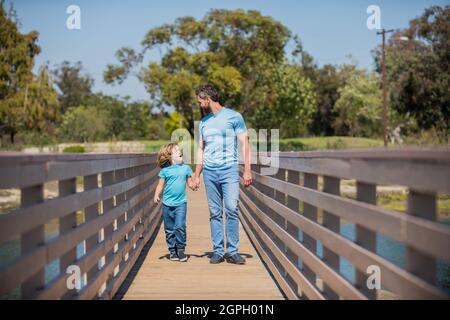 smiling father and son walking outdoor. family value. childhood and parenthood. Stock Photo