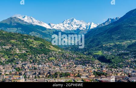 Panoramic view of Aosta with the Grand Combin mountain in the backogrund. Aosta Valley, northern Italy. Stock Photo