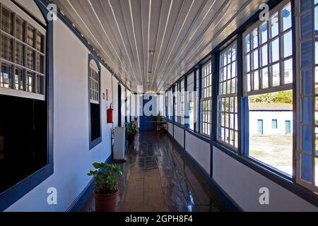 DIAMANTINA, MINAS GERAIS, BRAZIL - JANUARY 22, 2019: Corridor with colonial windows at Gloria's House (Casa da Gloria) Stock Photo