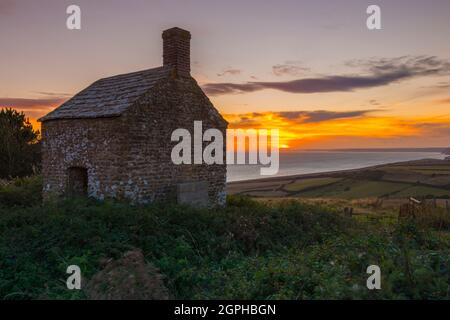 Puncknowle, Dorset, UK.  29th September 2021. The sunset viewed from the Grade II listed Lookout on the Knoll at Puncknowle in Dorset which has commanding views of the Jurassic Coast.  Picture Credit: Graham Hunt/Alamy Live News Stock Photo