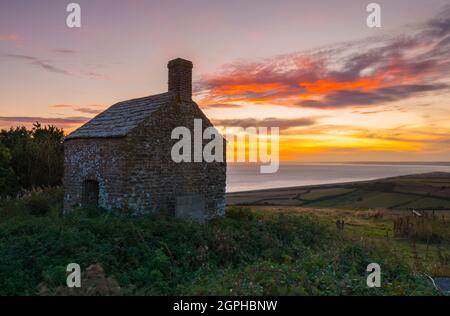 Puncknowle, Dorset, UK.  29th September 2021. The sunset viewed from the Grade II listed Lookout on the Knoll at Puncknowle in Dorset which has commanding views of the Jurassic Coast.  Picture Credit: Graham Hunt/Alamy Live News Stock Photo