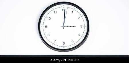 Wall clock shows time 3 o'clock on white isolated background. Round wall clock - front view. Fifteen o'clock Stock Photo